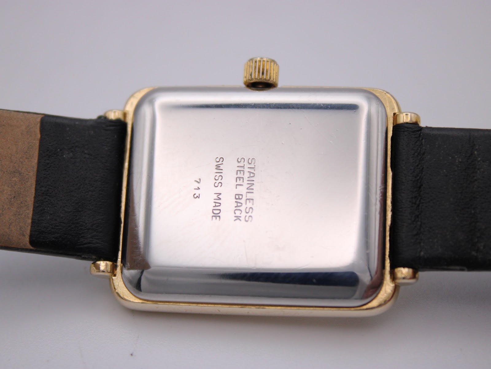 Back view of the Raymond Weil 713 watch, showing the polished stainless steel case back with "STAINLESS STEEL BACK SWISS MADE 713" engraved.