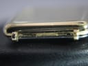 Extreme close-up of the side of the gold plated case, showing the "PLAQUE G 10 M" stamp indicating 10 micron gold plating.