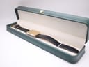 The Raymond Weil 713 watch neatly presented in an aftermarket green rectangular presentation box.