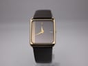 Front view of gold electroplated Raymond Weil 9118 with unique anthracite grey pinstripe dial and dark brown leather strap.
