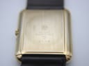 Close-up of the polished gold electroplated case back, engraved with "RW" logo, "18K GOLD ELECTROPLATED", "10M", and model number "9118".