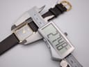 Digital caliper measuring the case width of the Raymond Weil 9118, displaying an exact measurement of 27.48 mm.