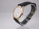 Side profile of vintage Seiko Quartz watch showing slim gold-tone case and crown.