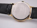 Detailed view of white dial with gold Roman numerals and 6 o'clock date window on Seiko 5Y39-7220.