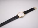 Reverse angle showing black crocodile grain leather strap texture and case back.