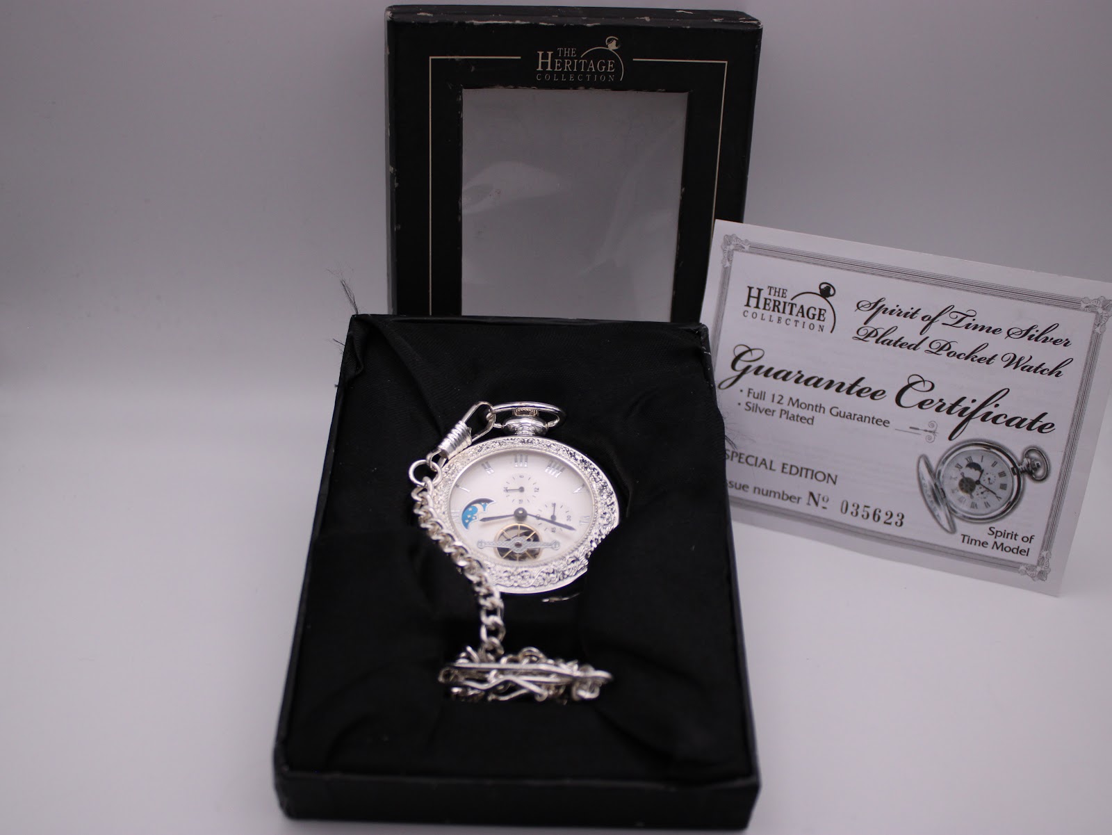 The Heritage Collection Spirit of Time pocket watch in its original open presentation box, alongside its guarantee certificate displaying the serial number 35623.